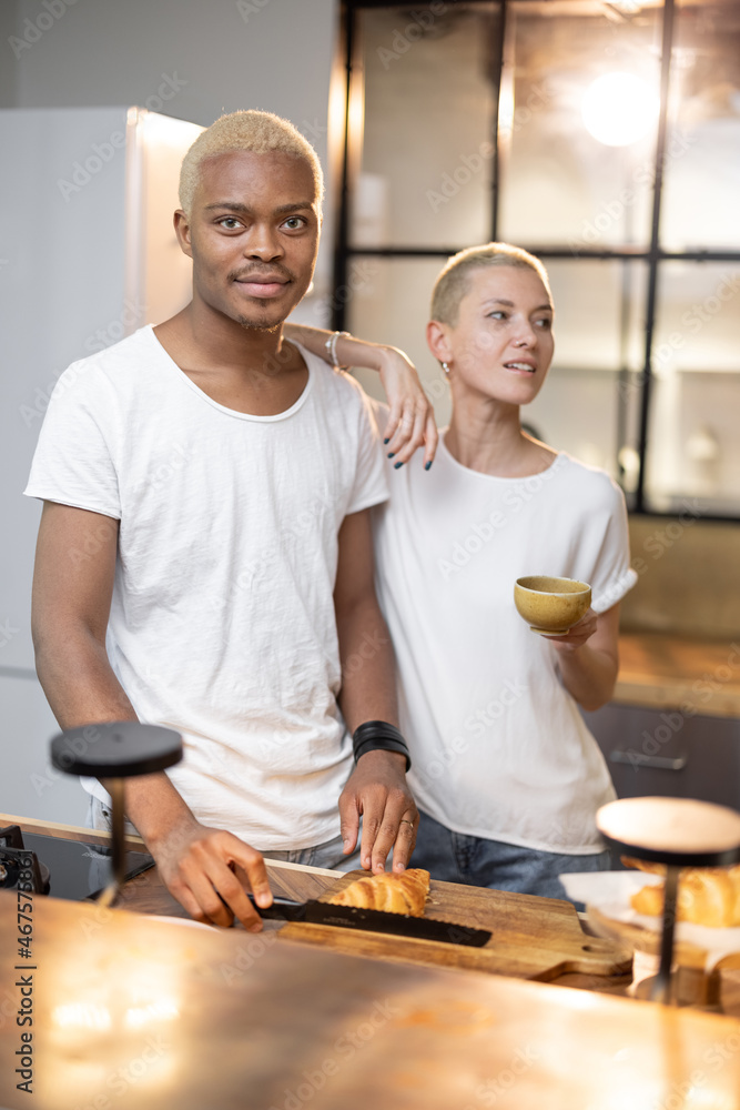 Multiracial couple making breakfast at home kitchen. Concept of relationship. Idea of modern domesti