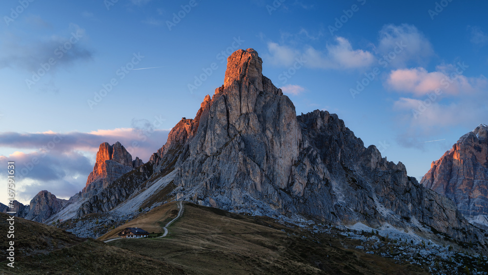 Giau Pass, Dolomite Alps, Italy. View of the mountains and high cliffs during sunset. Natural landsc