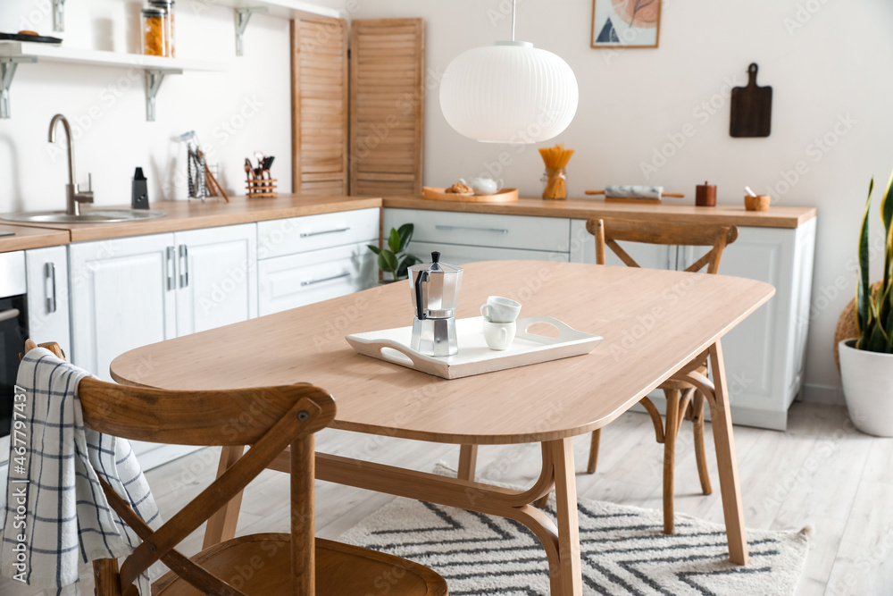 Stylish kitchen interior with wooden dining table