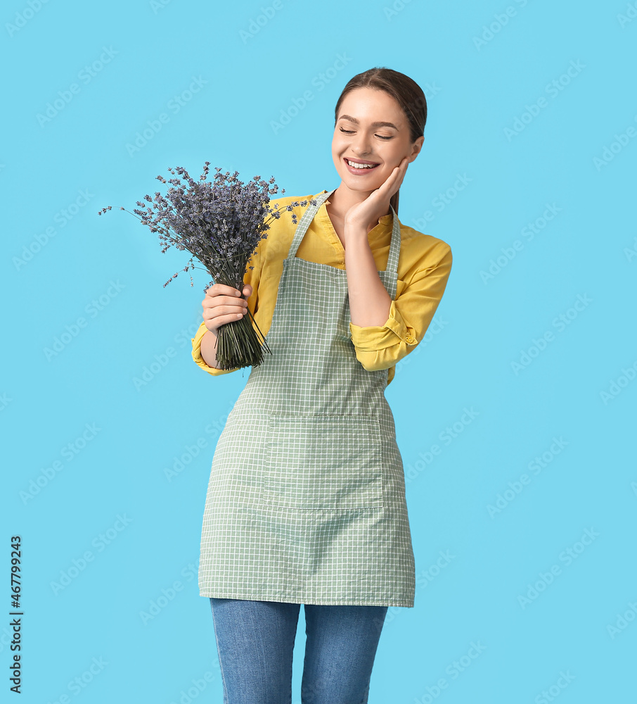 Female gardener with lavender on color background