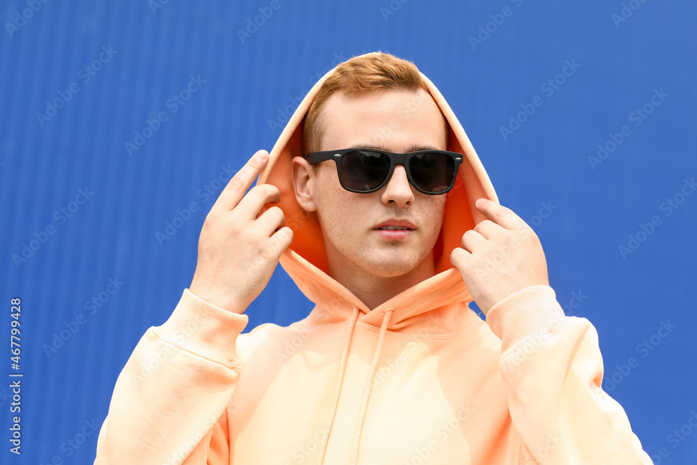 Young guy in stylish hoodie outdoors