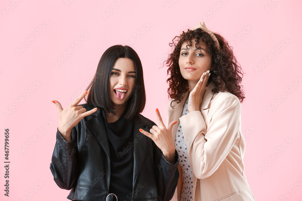 Portrait of different sisters on color background