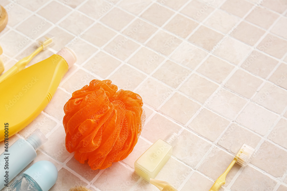 Different bath supplies on light tile, closeup