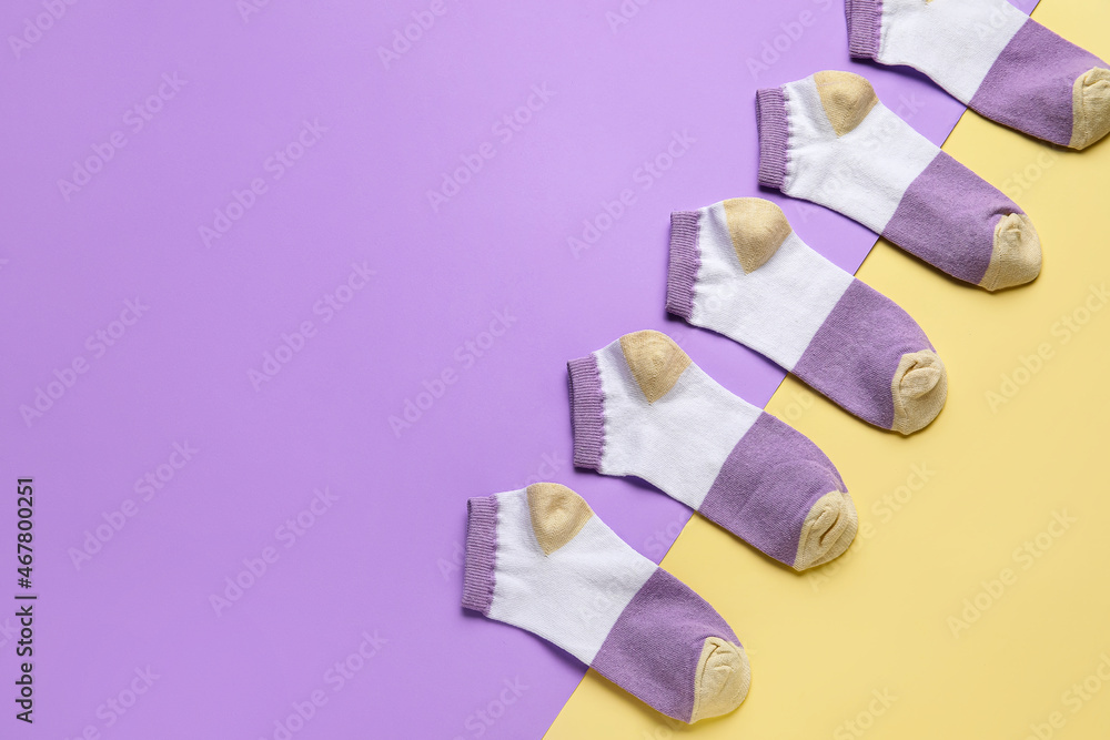 Many colorful socks on color background