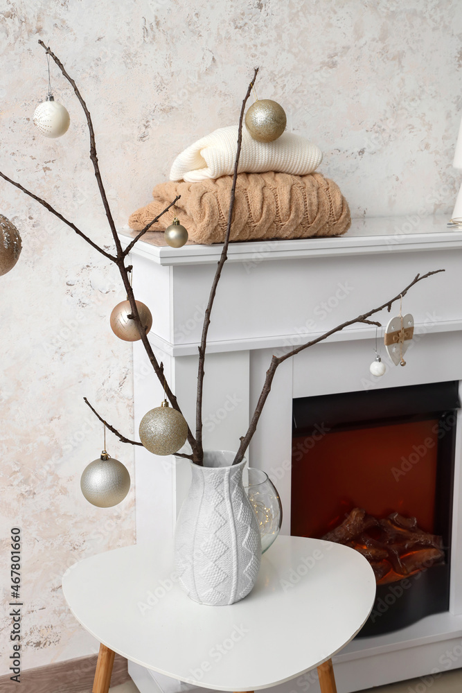 Modern fireplace with Christmas decoration in interior of room