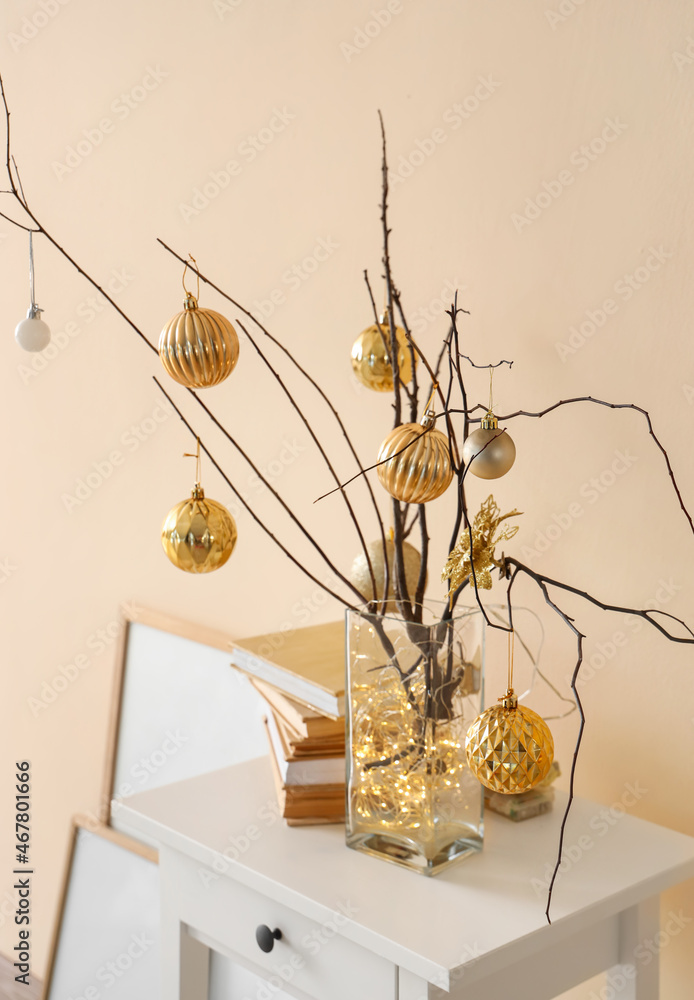 Christmas decoration with tree branches and festive balls on wall background