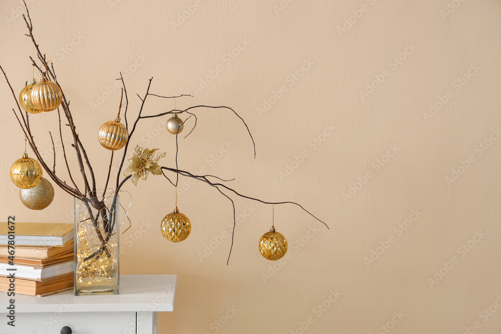 Christmas decoration with tree branches and festive balls on wall background