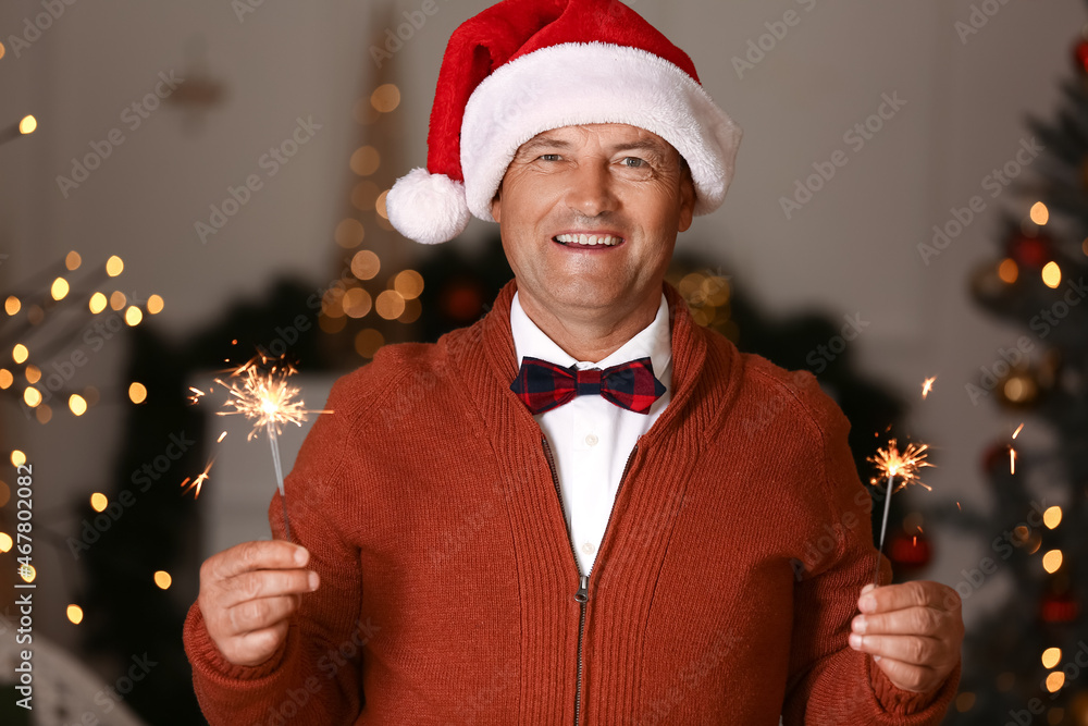 Mature man with Christmas sparklers at home