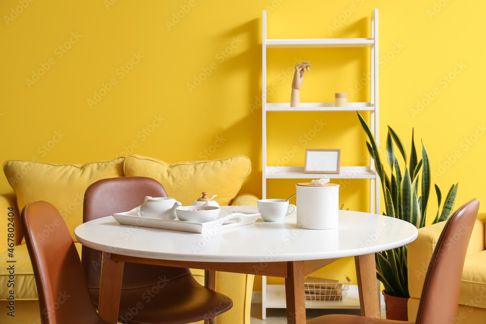 Dining table with teapot and tissue box in room