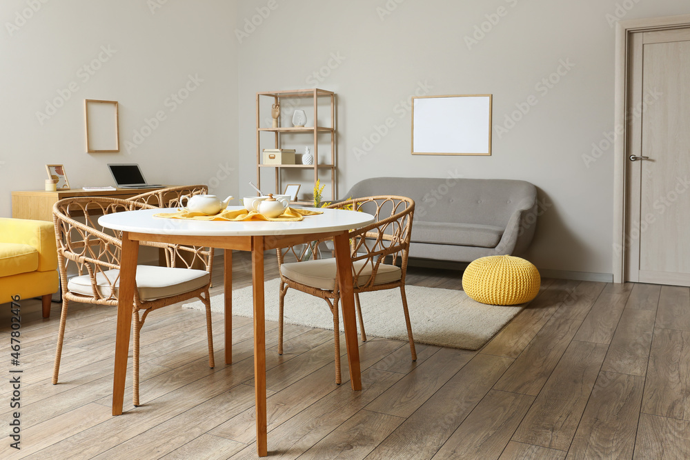 Dining table with wicker chairs in modern room