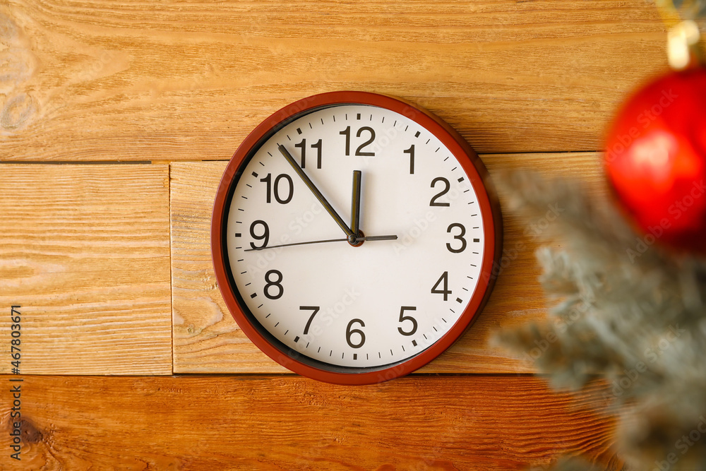 Christmas tree and clock on wooden wall