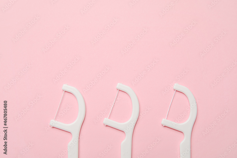 Floss toothpicks on color background, closeup