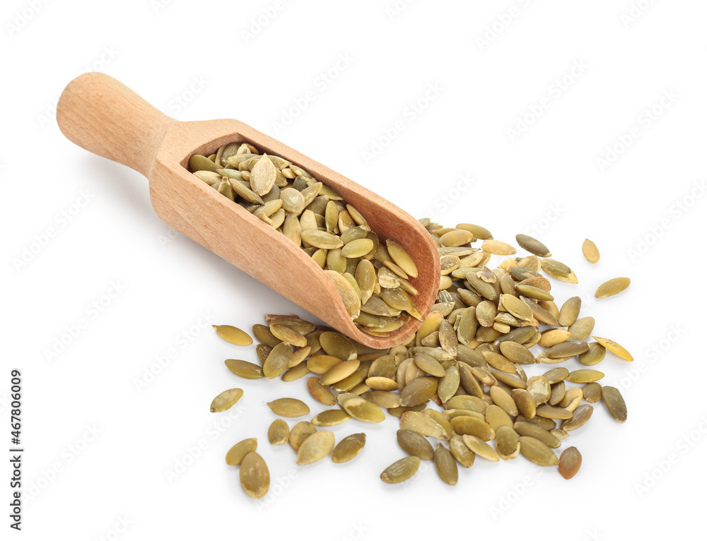 Scoop with natural pumpkin seeds on white background