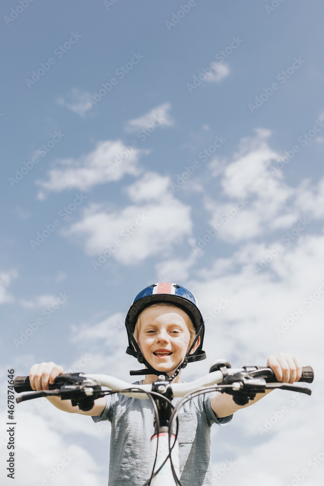 Kid’s hobby background, boy riding a bike, summer hobby