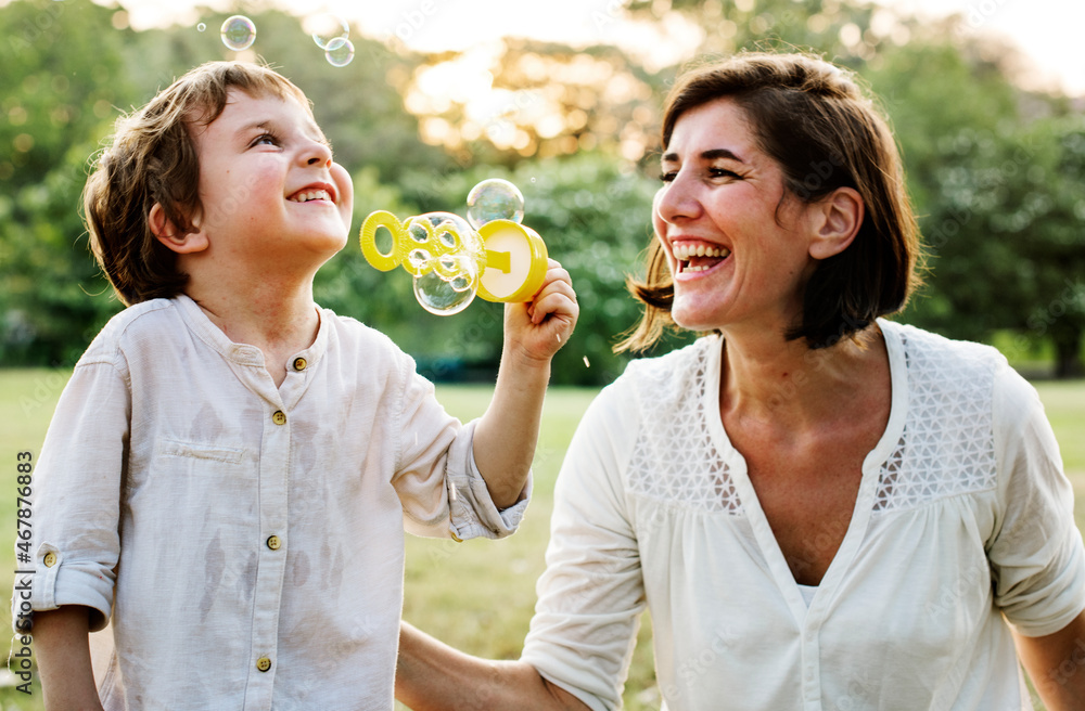 Teacher playing soap bubbles with her student