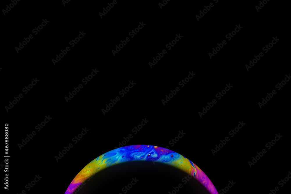 Abstract multicolor psychedelic planet in universe. Closeup soap bubble like an alien planet on dark