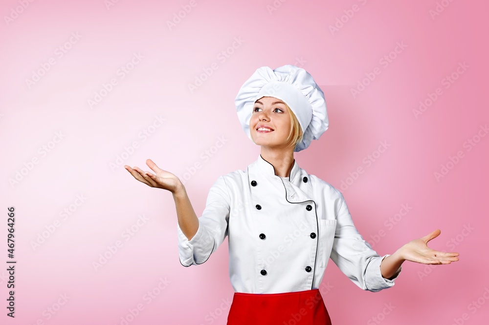 Cute young woman cook posing in white uniform