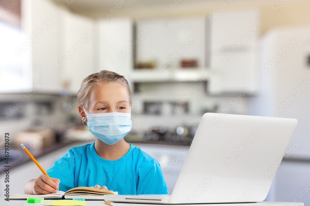 Smiling little child in headphones have a video call distant class using a laptop. Education concept