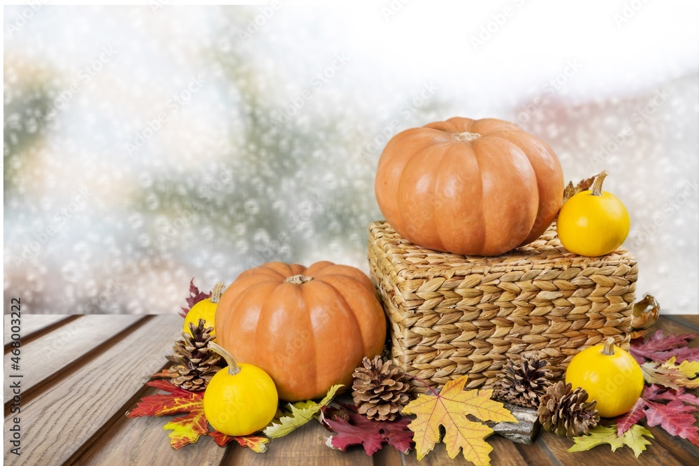 Autumn cozy mood composition on the windowsill. Pumpkins, dried leaves on the desk