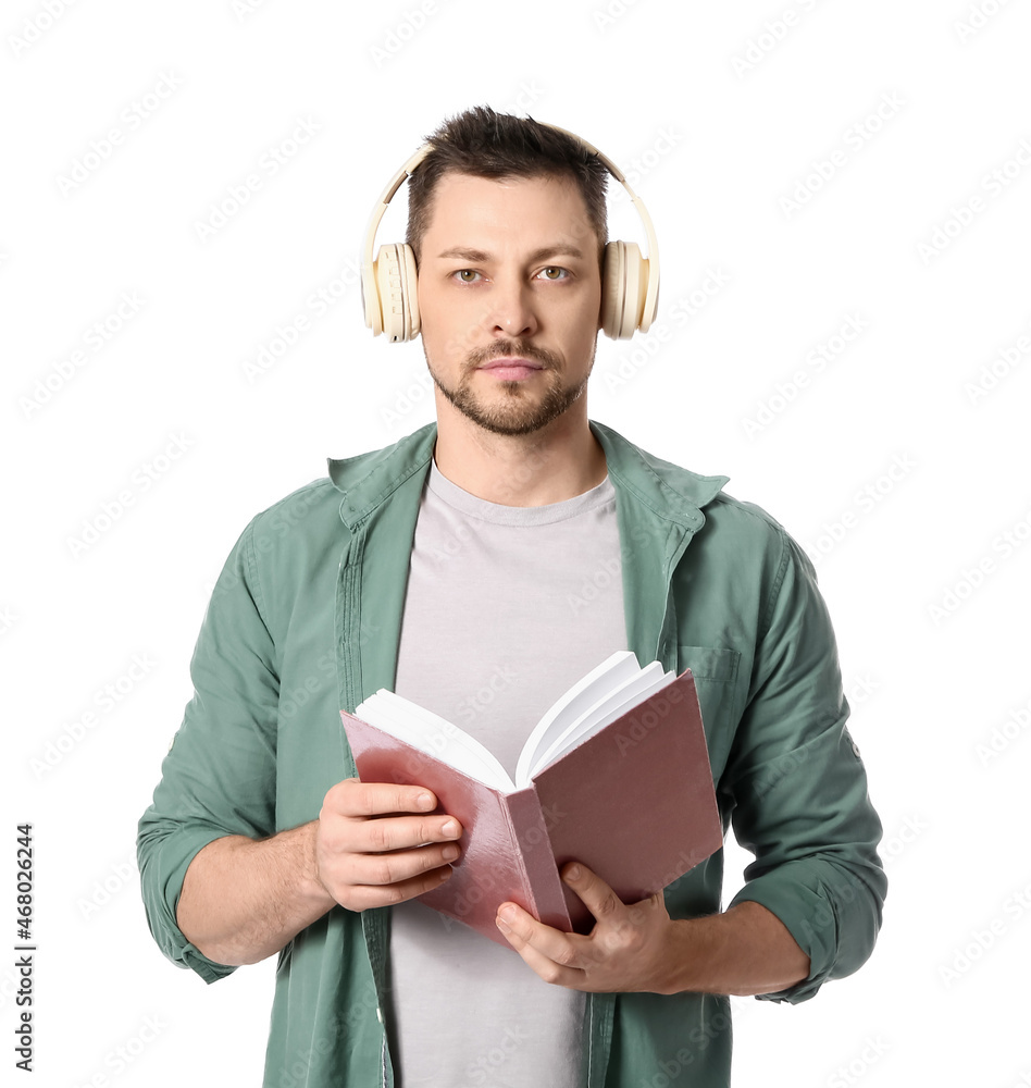 Man with headphones and book on white background