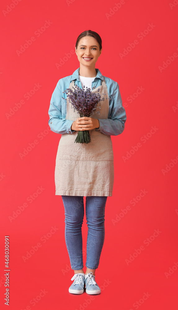 Female gardener with lavender on color background