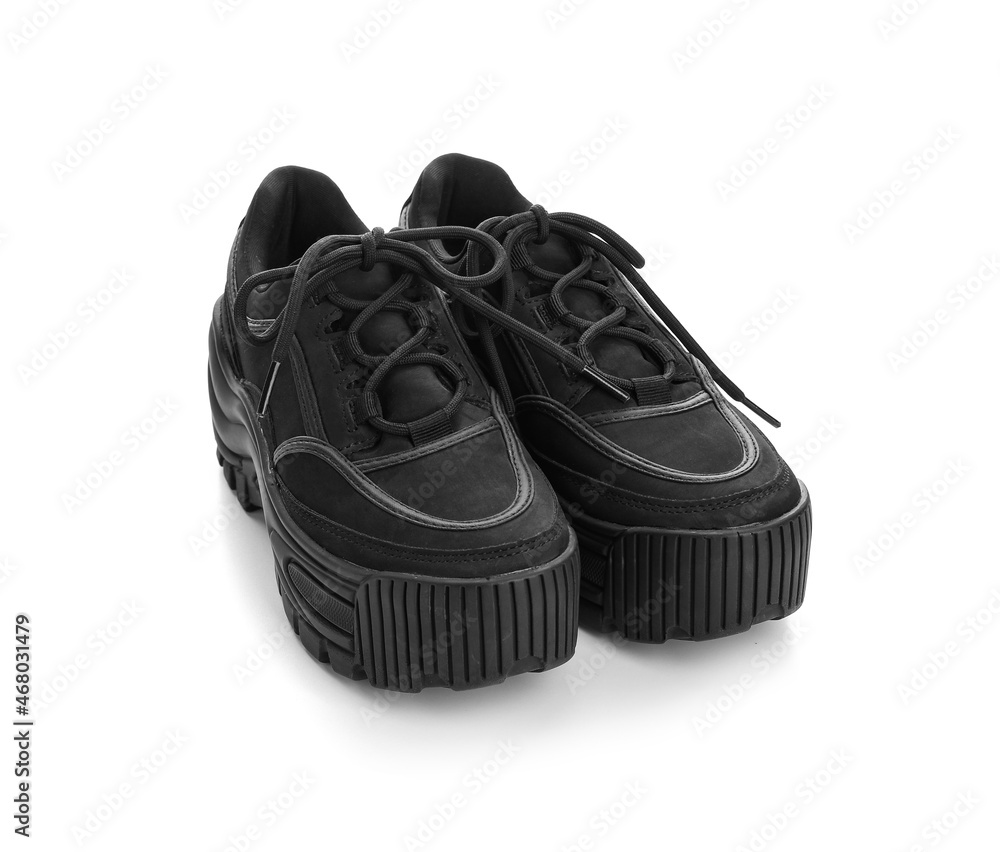 Pair of black shoes with laces on white background