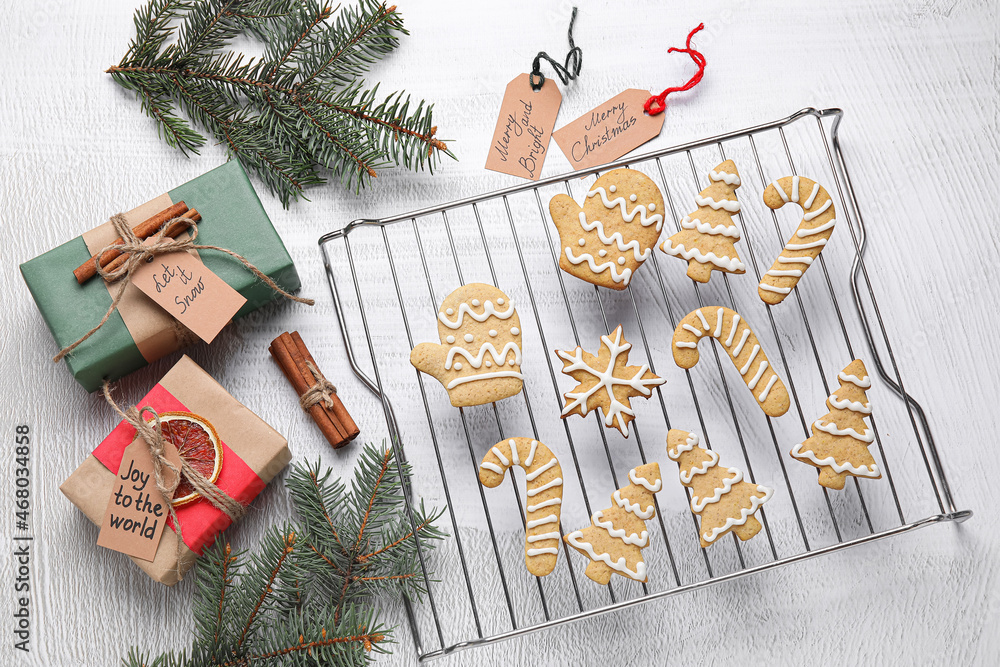 Composition with Christmas gingerbread cookies on light background