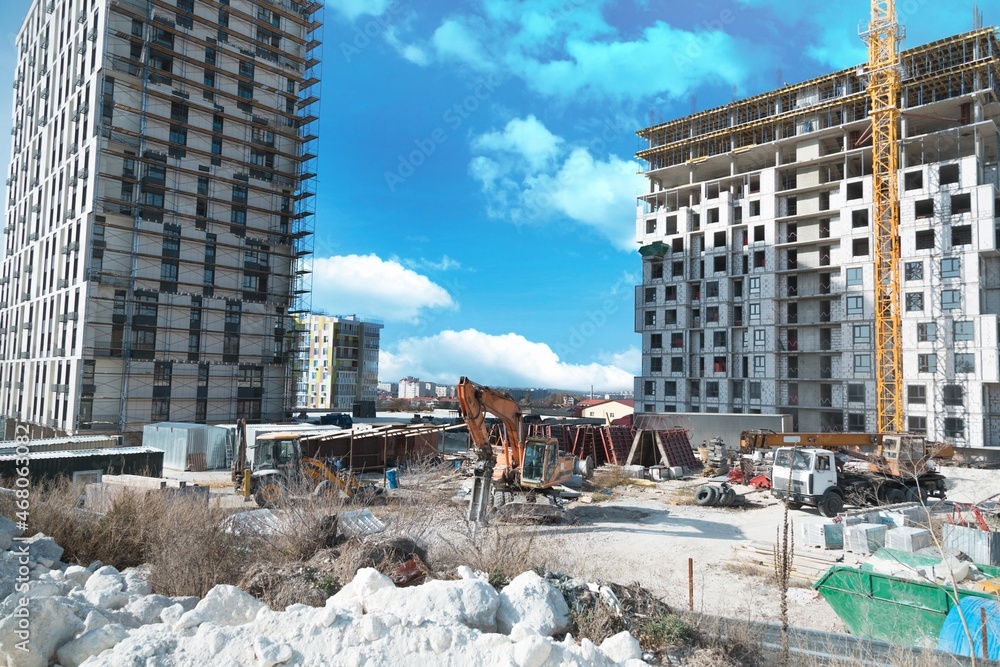 Construction site with cranes and building background