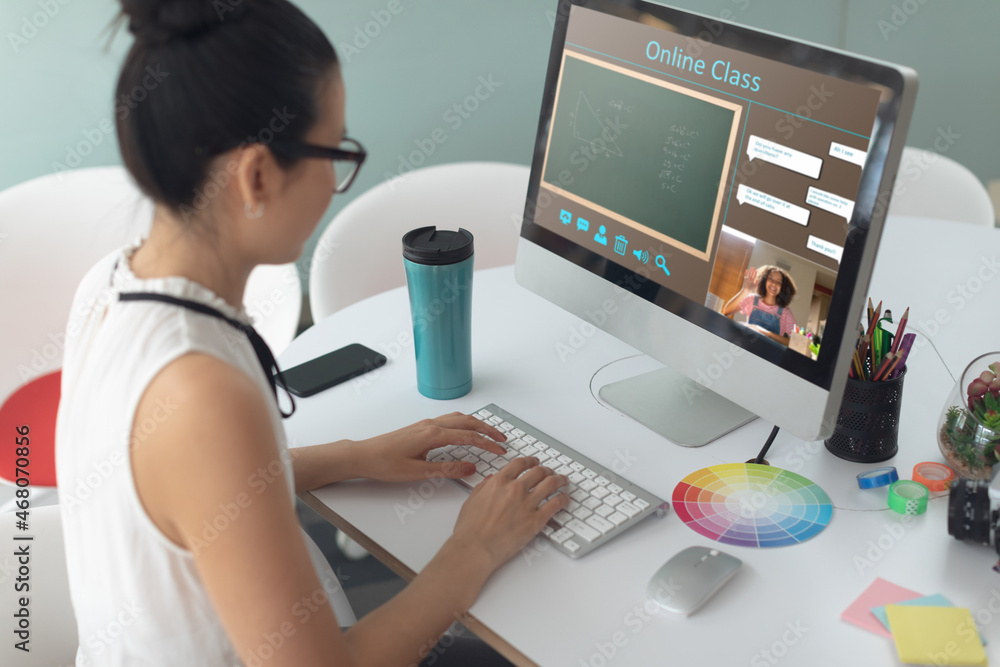 Caucasian girl using computer for video call, with smiling female teacher on screen