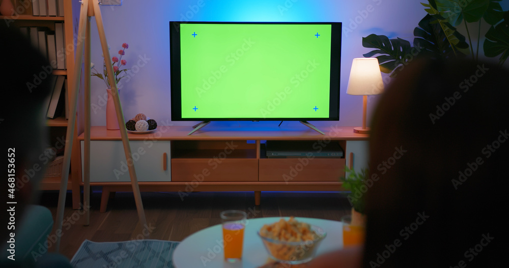 couple watch green screen TV