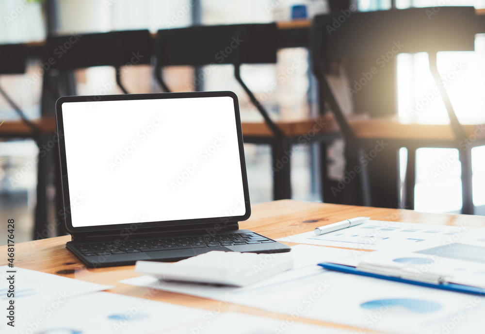 Laptop with blank screen on table. coffee shop blurred background.