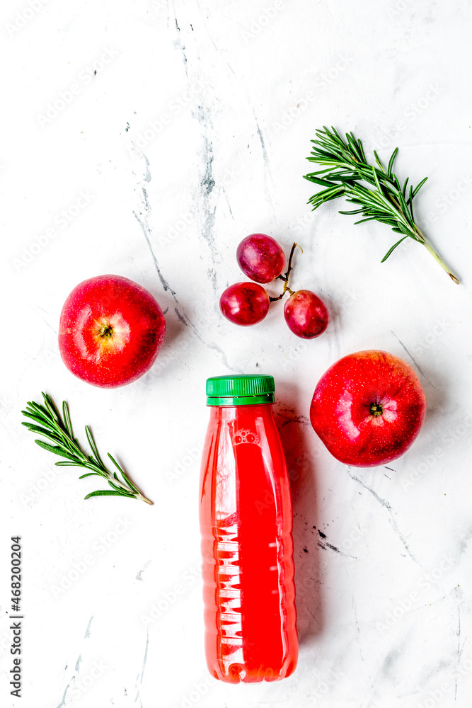 apple and grape juice in bottle on white background top view mockup