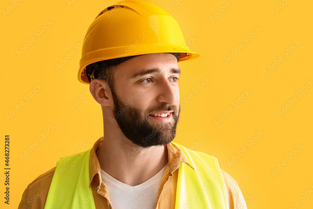 Construction worker in hardhat on yellow background