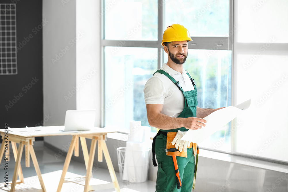 Construction worker with plan of house in room