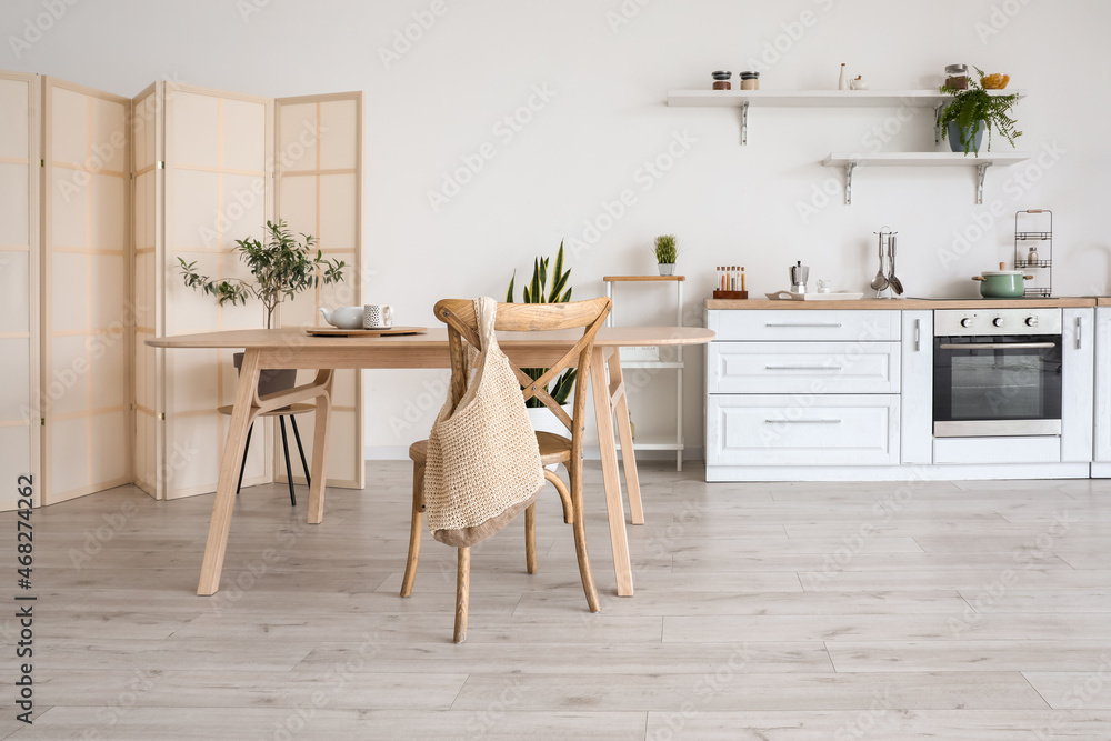 Stylish kitchen interior with wooden dining table