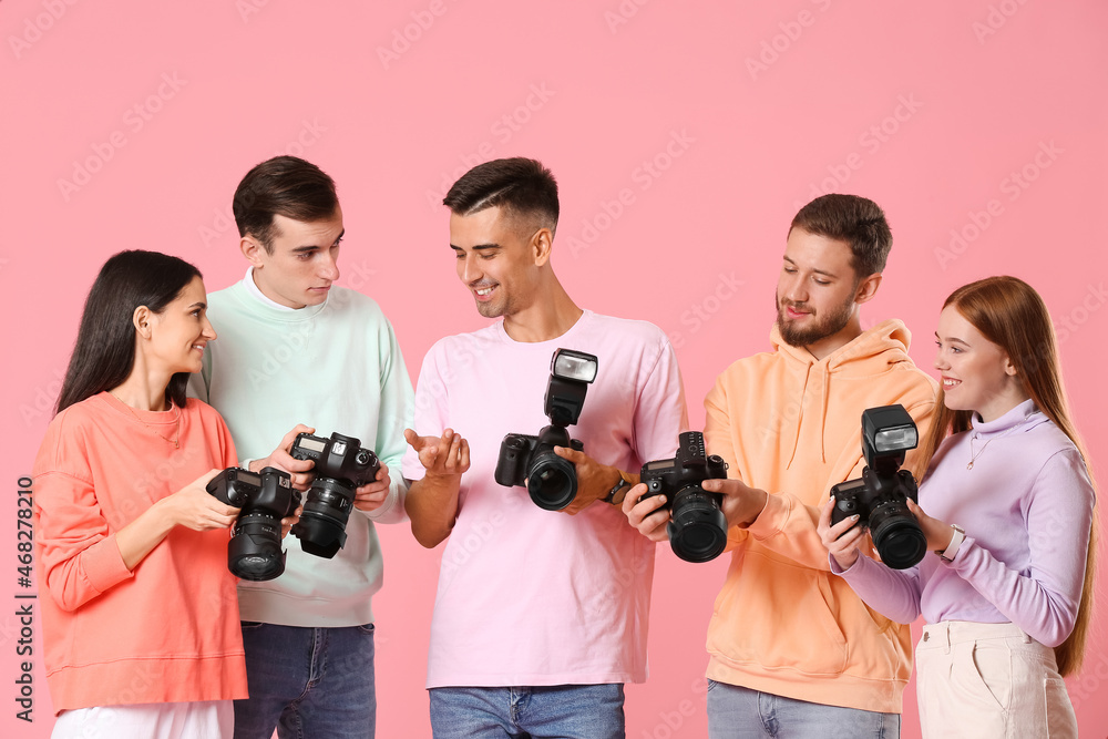 Group of photographers on color background