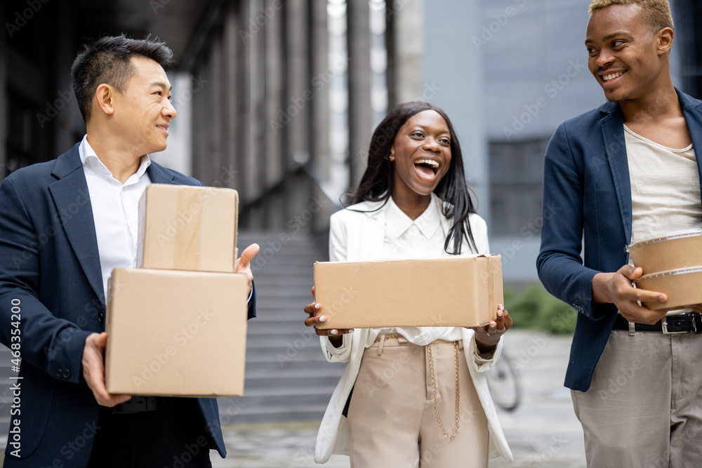 Multiracial business team with parcels walking on city street. Idea of shipping and logistics. Diver