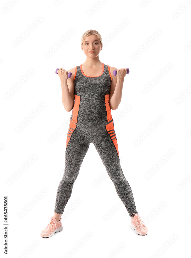 Young pregnant woman with dumbbells on white background