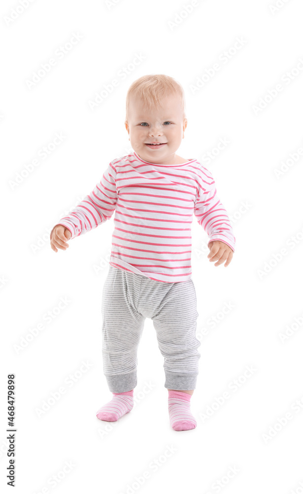 Cute baby girl learning to walk on white background