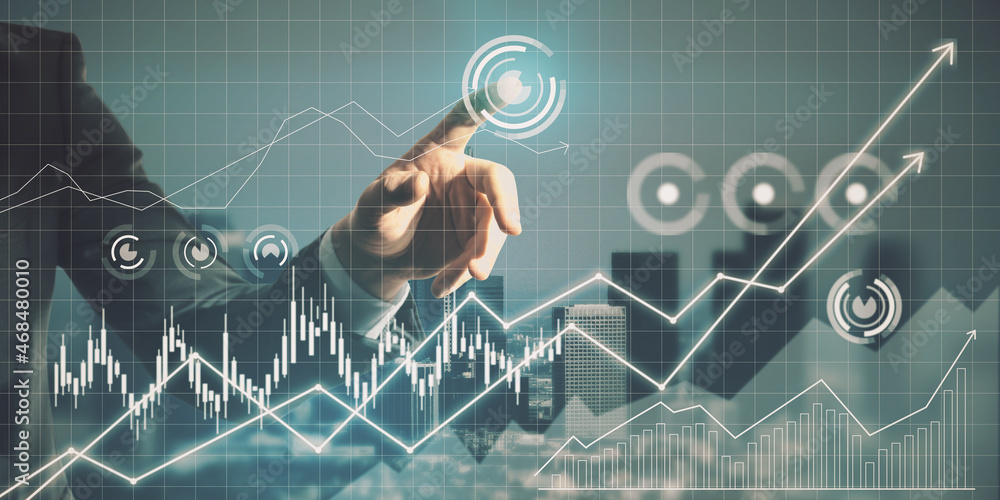 Close up of man hand pointing at glowing business chart grid on blurry city background. Finance and 