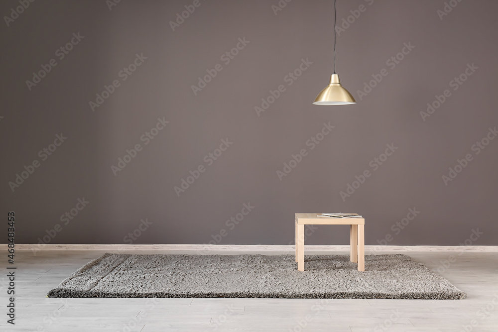 Table with magazines near dark wall