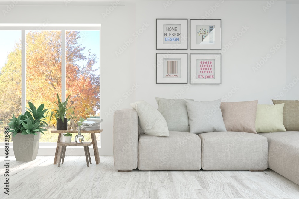 Stylish room in white color with sofa and autumn landscape in window. Scandinavian interior design. 