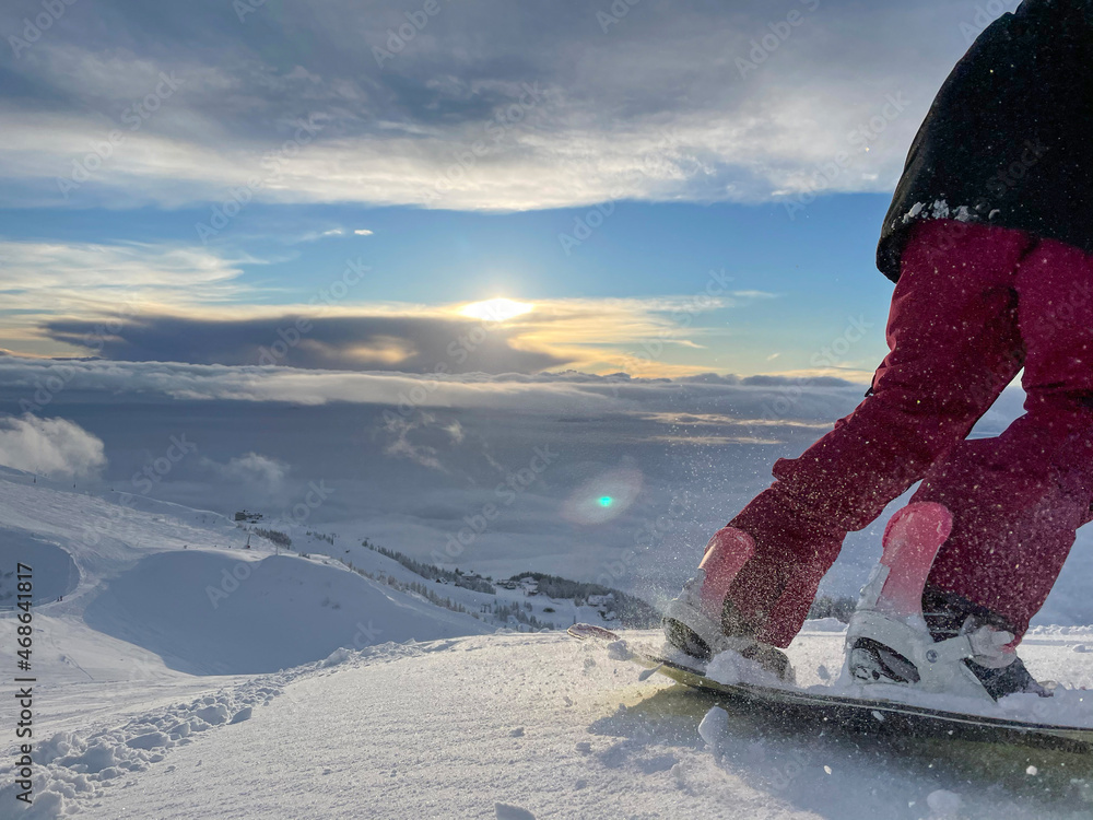 COPY SPACE: Unrecognizable woman shreds fresh snow while snowboarding off piste