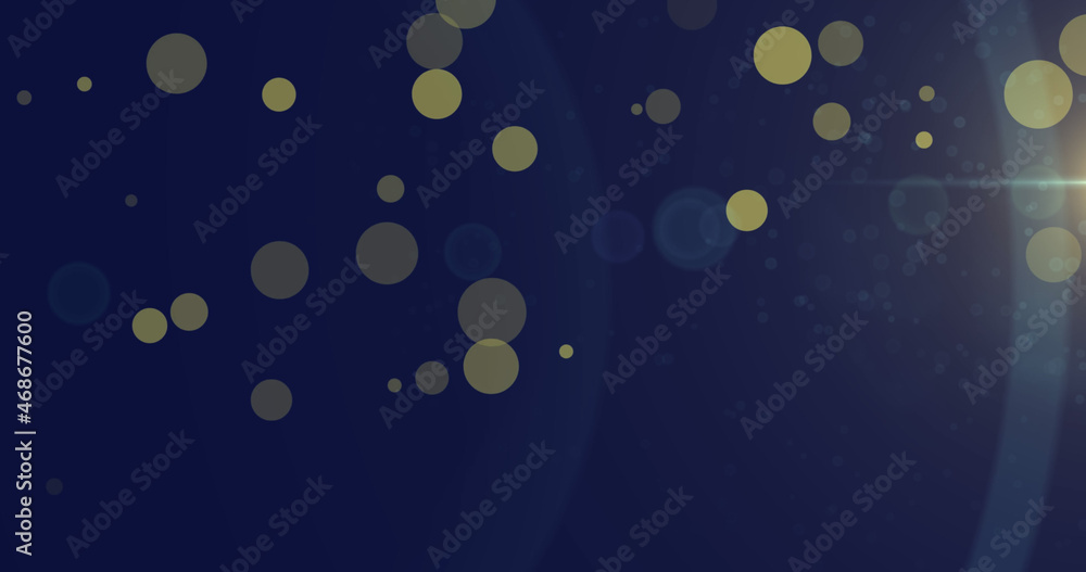 Image of light spots and trails on blue background