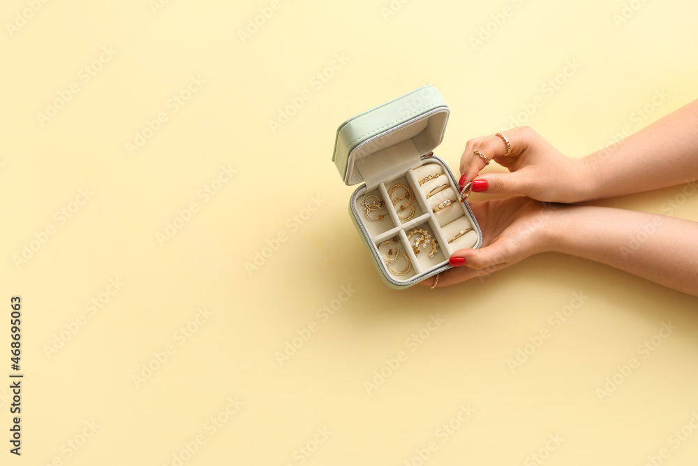 Young woman with beautiful manicure and jewelry box on color background