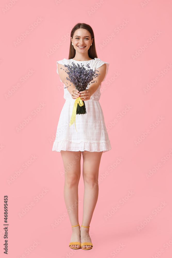 Beautiful young woman with bouquet of lavender on color background