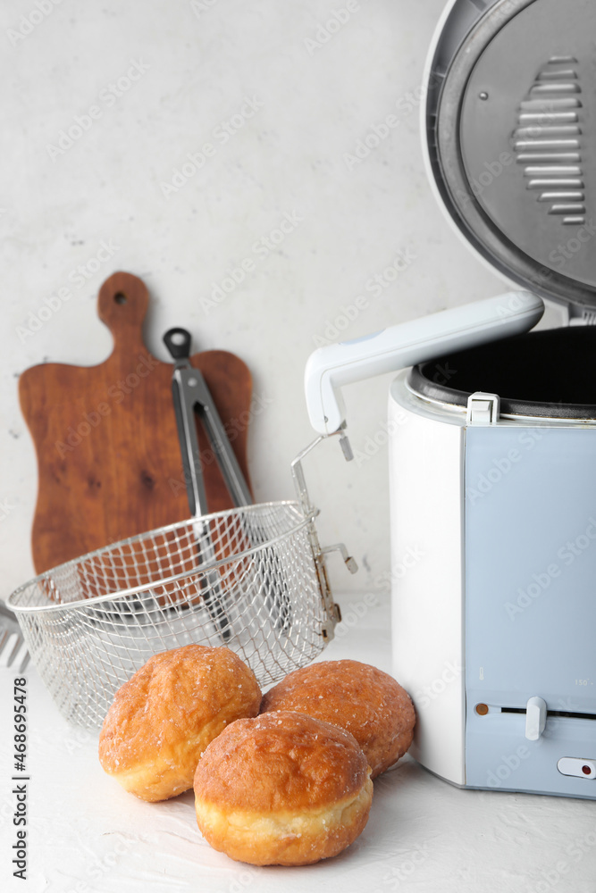 Tasty bakery near deep fryer on table