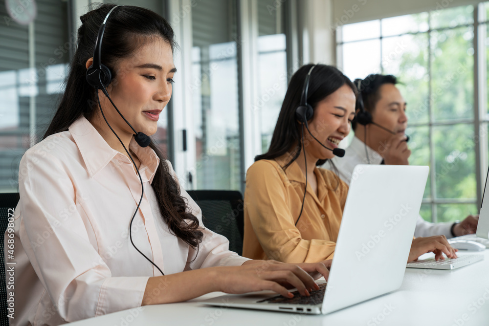 Business people wearing headset working actively in office . Call center, telemarketing, customer su