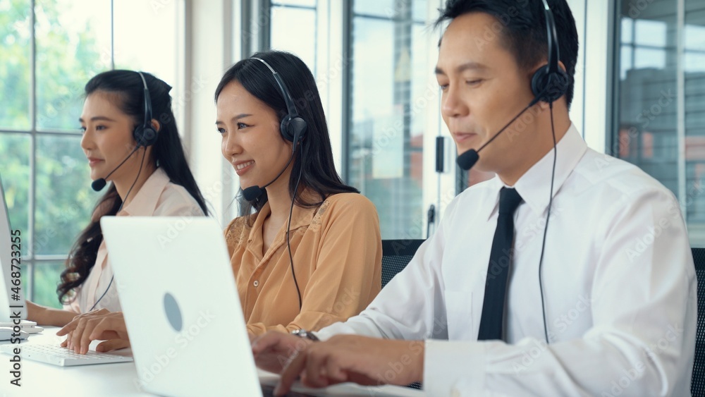 Business people wearing headset working actively in office . Call center, telemarketing, customer su