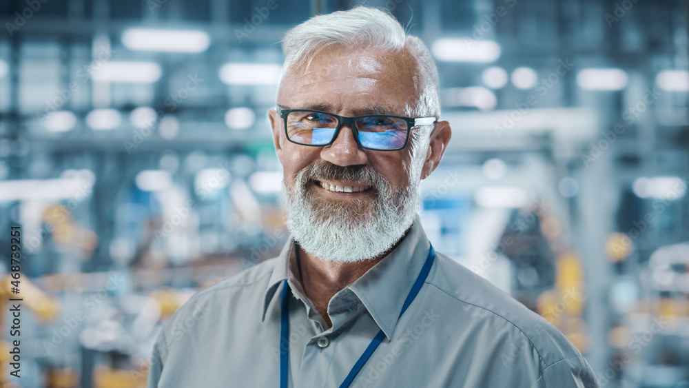 Car Factory Office: Portrait of Senior White Male Chief Engineer Looking at Camera and Smiling. Prof